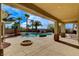 Covered patio view of the backyard featuring a pool, spa, barbecue, and palm trees at 5949 Casa Coronado Ave, Las Vegas, NV 89131