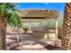 Outdoor barbecue and entertainment area with covered patio and lush landscaping at 5949 Casa Coronado Ave, Las Vegas, NV 89131