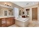 Bathroom featuring a soaking tub, double vanities, and natural light from a glass block window at 5949 Casa Coronado Ave, Las Vegas, NV 89131