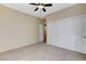Bedroom featuring neutral carpet, a ceiling fan, and closet with sliding doors at 5949 Casa Coronado Ave, Las Vegas, NV 89131