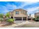 Stately two-story home featuring a three-car garage, desert landscaping, and an RV parking area behind a gated fence at 5949 Casa Coronado Ave, Las Vegas, NV 89131