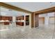 Open-concept living space with a large kitchen, center island, extensive cabinetry, and tiled flooring at 5949 Casa Coronado Ave, Las Vegas, NV 89131