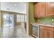 Bright living area with tile flooring, sliding glass doors to the pool, and a built-in bar with a wine fridge at 5949 Casa Coronado Ave, Las Vegas, NV 89131