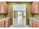 A bright living area with tile flooring and a doorway to a built-in bar area with a wine fridge at 5949 Casa Coronado Ave, Las Vegas, NV 89131