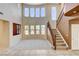 Bright living room with a staircase, high ceilings, tall windows, and neutral decor at 5949 Casa Coronado Ave, Las Vegas, NV 89131