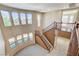 Bright living room featuring large windows, neutral walls, and tile flooring near the staircase at 5949 Casa Coronado Ave, Las Vegas, NV 89131
