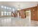 Bright living room with large staircase, open floor plan and easy access to the kitchen and entryway at 5949 Casa Coronado Ave, Las Vegas, NV 89131