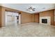 Bright living room featuring a fireplace, tile flooring, and an open layout, creating a cozy atmosphere at 5949 Casa Coronado Ave, Las Vegas, NV 89131