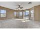 Large main bedroom with plush carpet, and natural light from multiple windows and a sliding glass door to a balcony at 5949 Casa Coronado Ave, Las Vegas, NV 89131