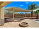 Outdoor kitchen with unique pergola and fire pit offer great entertainment space and landscaping at 5949 Casa Coronado Ave, Las Vegas, NV 89131