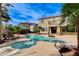 Backyard featuring a pool, spa, and lush landscaping, perfect for relaxing or entertaining at 5949 Casa Coronado Ave, Las Vegas, NV 89131
