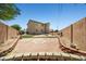 A landscaped backyard, with a patio area, desert landscaping, and block wall at 6088 Gulf Island Ave, Las Vegas, NV 89156