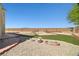Large, landscaped backyard with brick accents and desert landscaping at 6088 Gulf Island Ave, Las Vegas, NV 89156