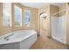 Bathroom featuring a soaking tub, a separate shower, and ample natural light at 6088 Gulf Island Ave, Las Vegas, NV 89156