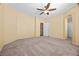 Spacious bedroom with carpet, a ceiling fan, and a doorway at 6088 Gulf Island Ave, Las Vegas, NV 89156