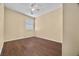 Cozy bedroom with a ceiling fan, window with blinds, and wood-look floors at 6088 Gulf Island Ave, Las Vegas, NV 89156