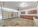 Functional garage with a three-car garage door and built-in storage cabinets at 6088 Gulf Island Ave, Las Vegas, NV 89156