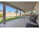 Spacious covered back patio with overhead lighting, outdoor seating, and artificial turf at 6141 Annville Ct, North Las Vegas, NV 89081