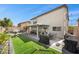 Fully fenced backyard featuring patio, artificial turf, barbecue, outdoor seating, and a swing at 6141 Annville Ct, North Las Vegas, NV 89081