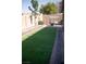 Spacious backyard featuring green turf with mature shade trees at 6141 Annville Ct, North Las Vegas, NV 89081