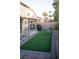 Landscaped backyard with artificial turf, patio and outdoor seating at 6141 Annville Ct, North Las Vegas, NV 89081
