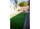 Spacious backyard features artificial grass perfect for outdoor activities and relaxation at 6141 Annville Ct, North Las Vegas, NV 89081