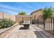 Backyard featuring a modern fire pit, patio, privacy fence, and low-maintenance landscaping at 6141 Annville Ct, North Las Vegas, NV 89081
