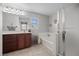 Tidy bathroom with tub, shower, and wood vanity at 6141 Annville Ct, North Las Vegas, NV 89081