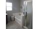 Bathroom boasts a shower, separate tub and window for natural light at 6141 Annville Ct, North Las Vegas, NV 89081