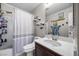Bathroom with white vanity, tiled shower with curtain, and nautical décor on light gray walls at 6141 Annville Ct, North Las Vegas, NV 89081