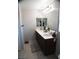 Bathroom features double sink vanity, decorative mirror and tiled flooring at 6141 Annville Ct, North Las Vegas, NV 89081