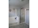 Bathroom showcasing a bathtub, separate shower and coastal decor at 6141 Annville Ct, North Las Vegas, NV 89081