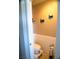Small bathroom featuring wood plank accents on the walls and cute turtle decorations at 6141 Annville Ct, North Las Vegas, NV 89081