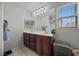 Well-lit bathroom showcasing a double vanity and roomy mirrors at 6141 Annville Ct, North Las Vegas, NV 89081