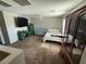 Bedroom featuring carpeted floors, crib, bed, window, ceiling fan, TV and dark wooden furniture at 6141 Annville Ct, North Las Vegas, NV 89081