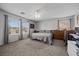 Sunlit bedroom showcasing a comfortable bed, desk, and neighborhood views at 6141 Annville Ct, North Las Vegas, NV 89081