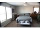 This is a well-lit bedroom featuring carpet flooring, neutral walls, and a ceiling fan at 6141 Annville Ct, North Las Vegas, NV 89081