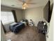 This is a bedroom with a ceiling fan, and a TV mounted on the wall at 6141 Annville Ct, North Las Vegas, NV 89081