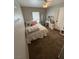 Neutral bedroom with carpet flooring, large window, and vanity at 6141 Annville Ct, North Las Vegas, NV 89081