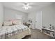 Cozy bedroom featuring a ceiling fan, plush carpet, and a bright window for natural light at 6141 Annville Ct, North Las Vegas, NV 89081