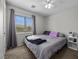 Well-lit bedroom with large window and neutral decor at 6141 Annville Ct, North Las Vegas, NV 89081