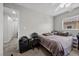 Cozy bedroom with neutral walls, window, and carpet featuring a ceiling fan and luggage at 6141 Annville Ct, North Las Vegas, NV 89081