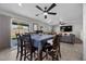 This dining area has tile floors, a ceiling fan, and a sliding glass door for natural light and backyard access at 6141 Annville Ct, North Las Vegas, NV 89081