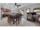 Open dining area features a modern ceiling fan, tile floors, and a sliding glass door to the backyard at 6141 Annville Ct, North Las Vegas, NV 89081