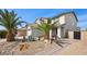 Inviting two-story home featuring desert landscaping, palm trees and a two-car garage at 6141 Annville Ct, North Las Vegas, NV 89081