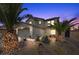 Inviting two-story home featuring desert landscaping, palm trees and a two-car garage at 6141 Annville Ct, North Las Vegas, NV 89081