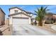 Charming two-story home featuring an attached two-car garage and desert landscaping at 6141 Annville Ct, North Las Vegas, NV 89081
