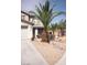 Front yard with desert landscaping featuring multiple palm trees and drought resistant plants at 6141 Annville Ct, North Las Vegas, NV 89081
