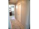 Neutral hallway leading to the bathroom, featuring tile flooring and ample lighting at 6141 Annville Ct, North Las Vegas, NV 89081