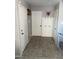 Hallway area featuring neutral wall color and baseboards, decorative wall decor, and tile flooring at 6141 Annville Ct, North Las Vegas, NV 89081